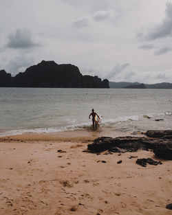 Man on beach against sky