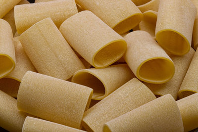 Fresh italian uncooked pasta paccheri background.