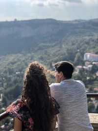 Rear view of couple standing against mountain