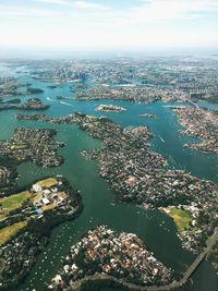 High angle view of cityscape by sea against sky