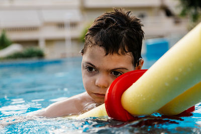 Portrait of boy swimming in pool