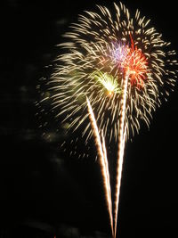 Low angle view of firework display at night