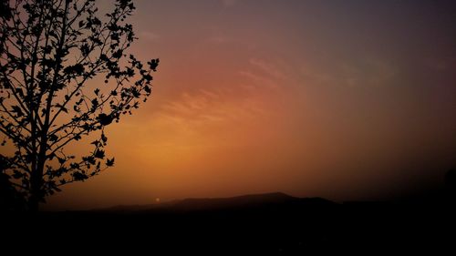 Scenic view of silhouette landscape against romantic sky at sunset