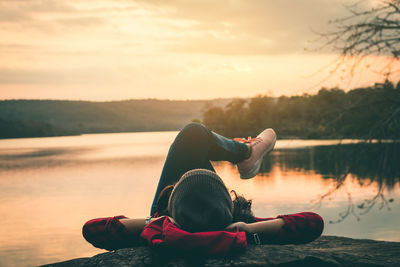 Woman relaxing at lakeshore