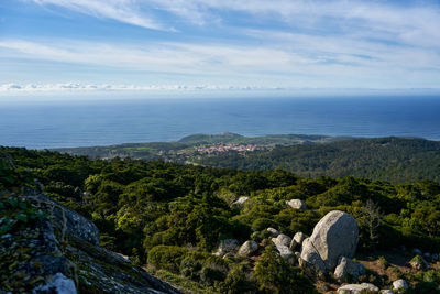 High angle view of rocks by sea against sky