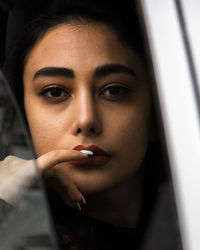 Close-up of young woman in car