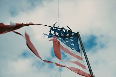 Low angle view of flags against sky