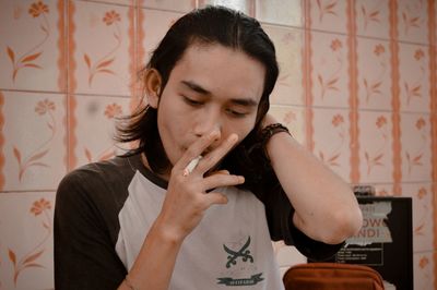 Portrait of young woman smoking cigarette