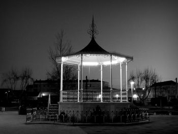 Illuminated built structure against clear sky at night