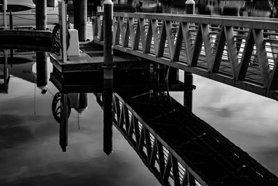 Empty pier amidst buildings against sky