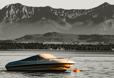 Boat in lake against mountains