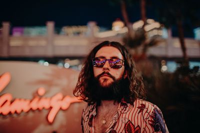 Portrait of young man wearing sunglasses standing outdoors