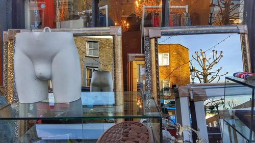 Mirrors outside store with buildings reflecting