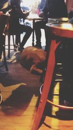 Low section of boy sitting on table in cafe