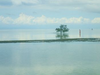 Scenic view of sea against cloudy sky