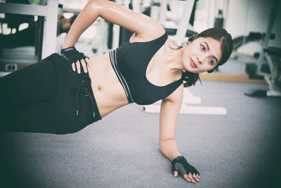 Young woman exercising in gym