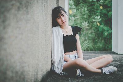 Portrait of young woman sitting outdoors