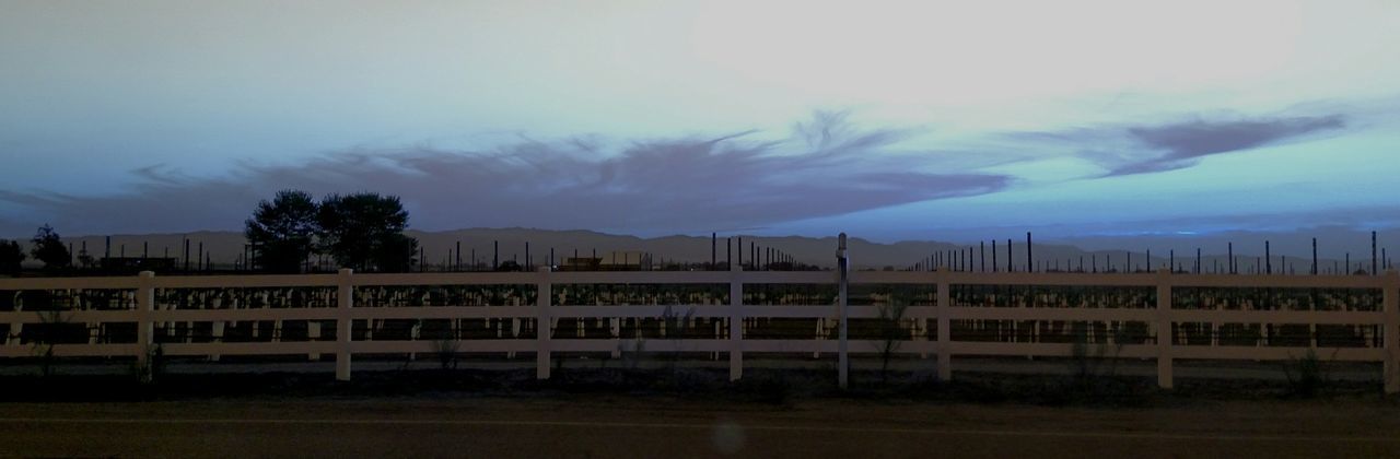 architecture, building exterior, built structure, sky, cloud - sky, dusk, railing, cloudy, outdoors, nature, no people, house, weather, cloud, city, water, overcast, transportation, tree, residential structure