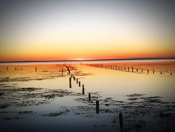 Scenic view of sea against clear sky at sunset