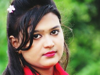 Close-up portrait of young woman wearing pink lipstick