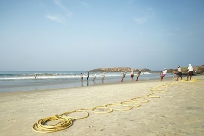 Scenic view of people on beach 