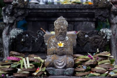 Statue outside temple against building