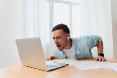 Young woman using laptop at office