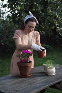 Rear view of girl holding flower pot