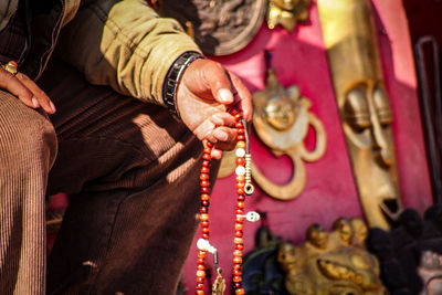 Close-up of hand holding prayer beads