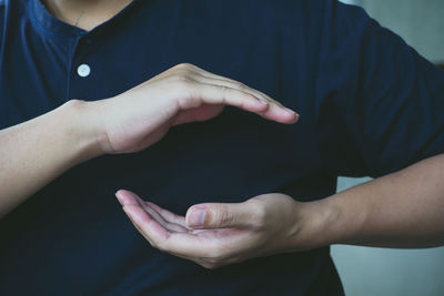 Midsection of man with hands