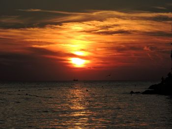 Scenic view of sea against orange sky