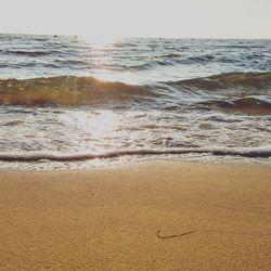 Scenic view of beach against sky during sunset