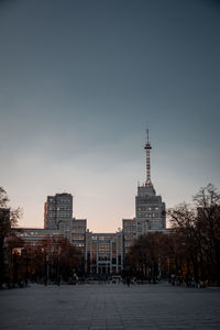 Buildings in city against clear sky