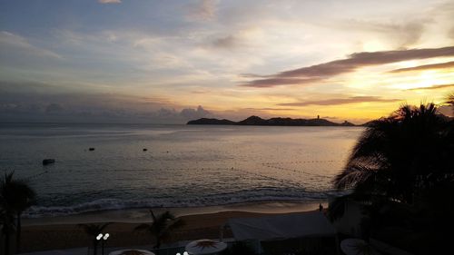 Scenic view of beach against sky during sunset