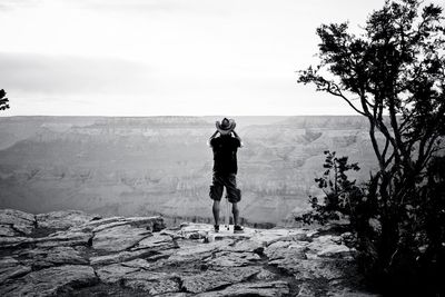 Rear view of woman standing on landscape