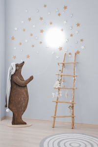 Creative lamp in the children's room. drawn bear holding a rope with a lamp on the wall