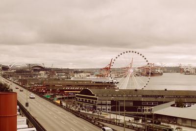 Ferris wheel in city against sky