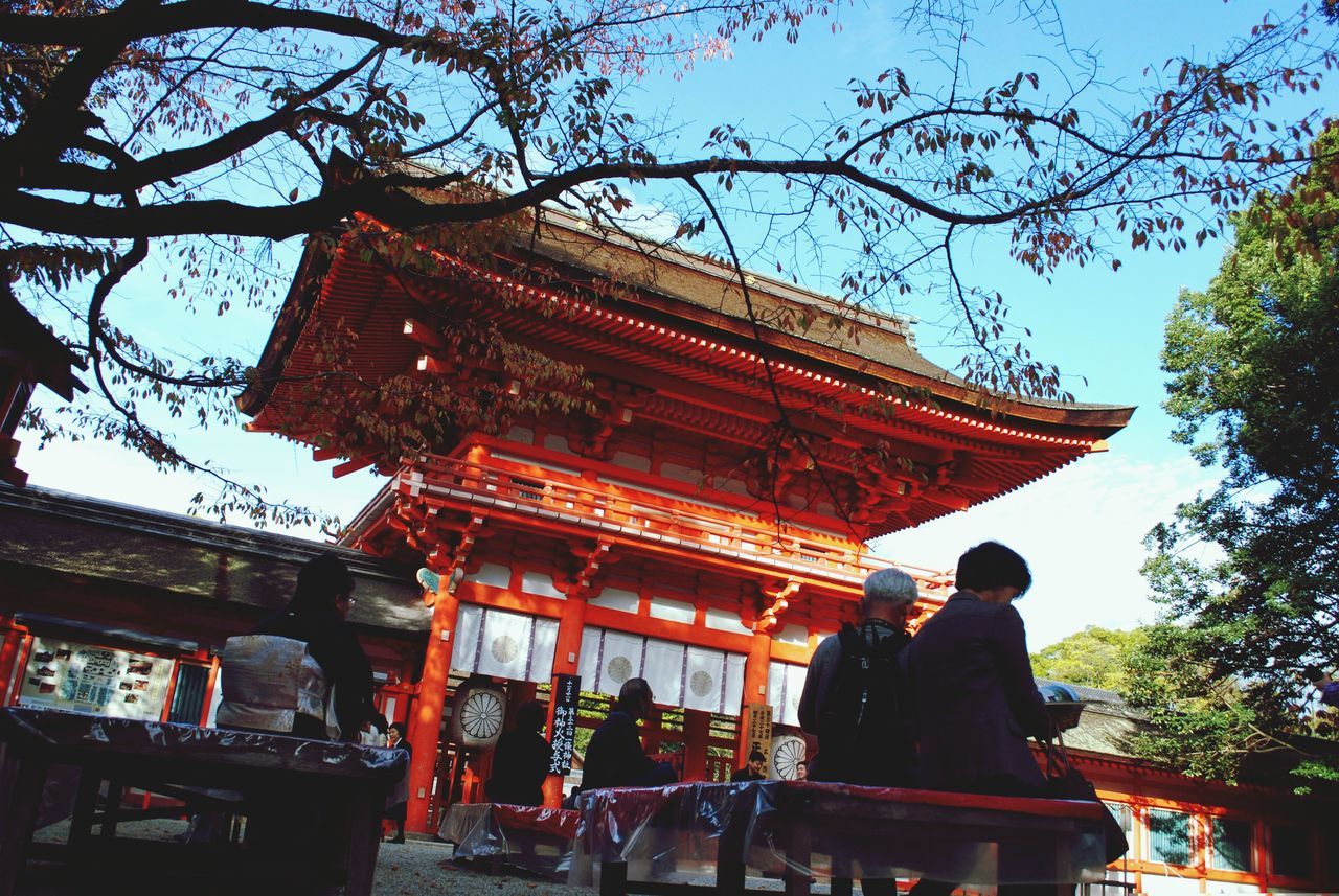 temple - building, place of worship, built structure, architecture, religion, spirituality, building exterior, tree, person, large group of people, low angle view, travel destinations, tradition, famous place, cultures, men, temple, tourism