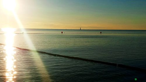 Scenic view of sea against sky at sunset