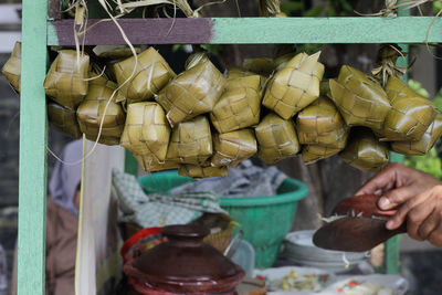 Midsection of man having food at market stall