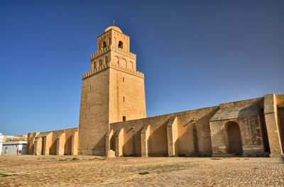 Low angle view of historical building against clear blue sky