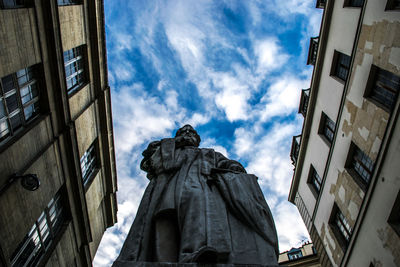 Low angle view of building against cloudy sky