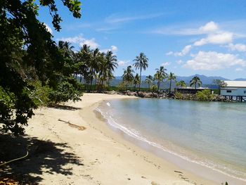 Scenic view of beach against cloudy sky