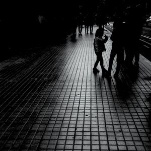 Rear view of people walking outdoors