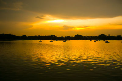 Scenic view of lake against romantic sky at sunset