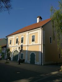 Street by building against clear blue sky