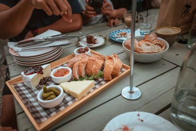 Cropped hand of woman having food on table