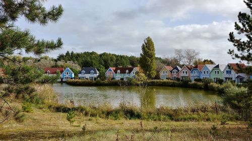 Built structure by trees against sky