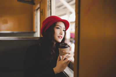 Young woman drinking coffee in cup