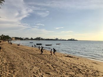 People on beach against sky